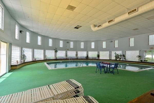 6 Shadowbrook Lane, Unit 59 Milford, MA 01757 - Photo 22 of 25 a view of a house with a swimming pool