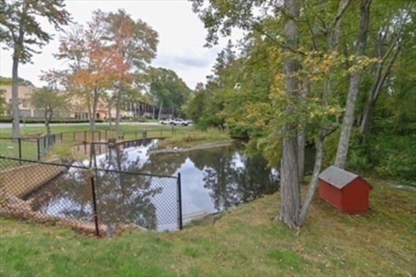 6 Shadowbrook Lane, Unit 59 Milford, MA 01757 - Photo 23 of 25 a view of a garden with wooden fence