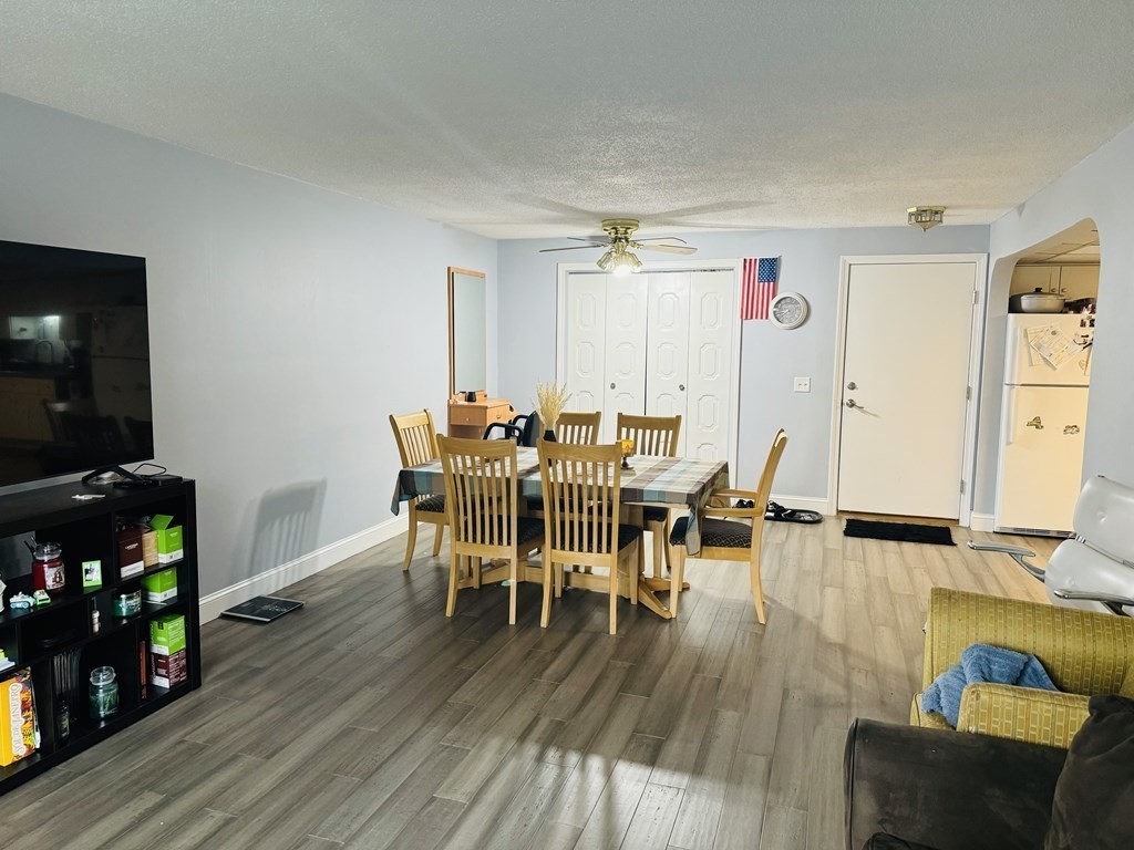 6 Shadowbrook Lane, Unit 59 Milford, MA 01757 - Photo 3 of 25 a living room with furniture and a flat screen tv