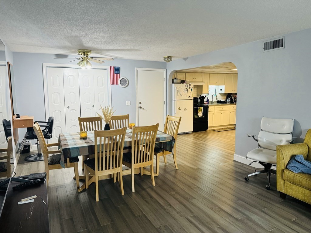 6 Shadowbrook Lane, Unit 59 Milford, MA 01757 - Photo 4 of 25 a view of a dining room with furniture and wooden floor