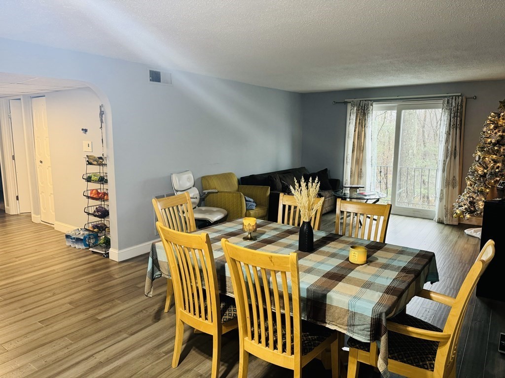 6 Shadowbrook Lane, Unit 59 Milford, MA 01757 - Photo 5 of 25 a view of a dining room with furniture and wooden floor