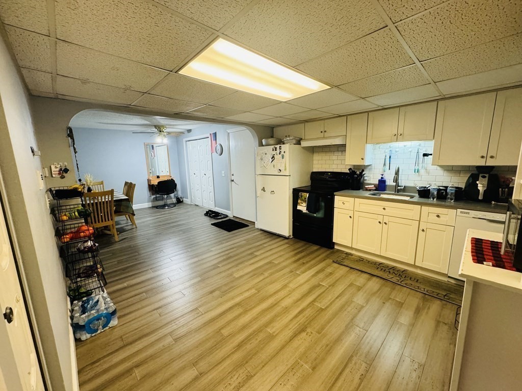 6 Shadowbrook Lane, Unit 59 Milford, MA 01757 - Photo 8 of 25 a kitchen with granite countertop a sink window and cabinets