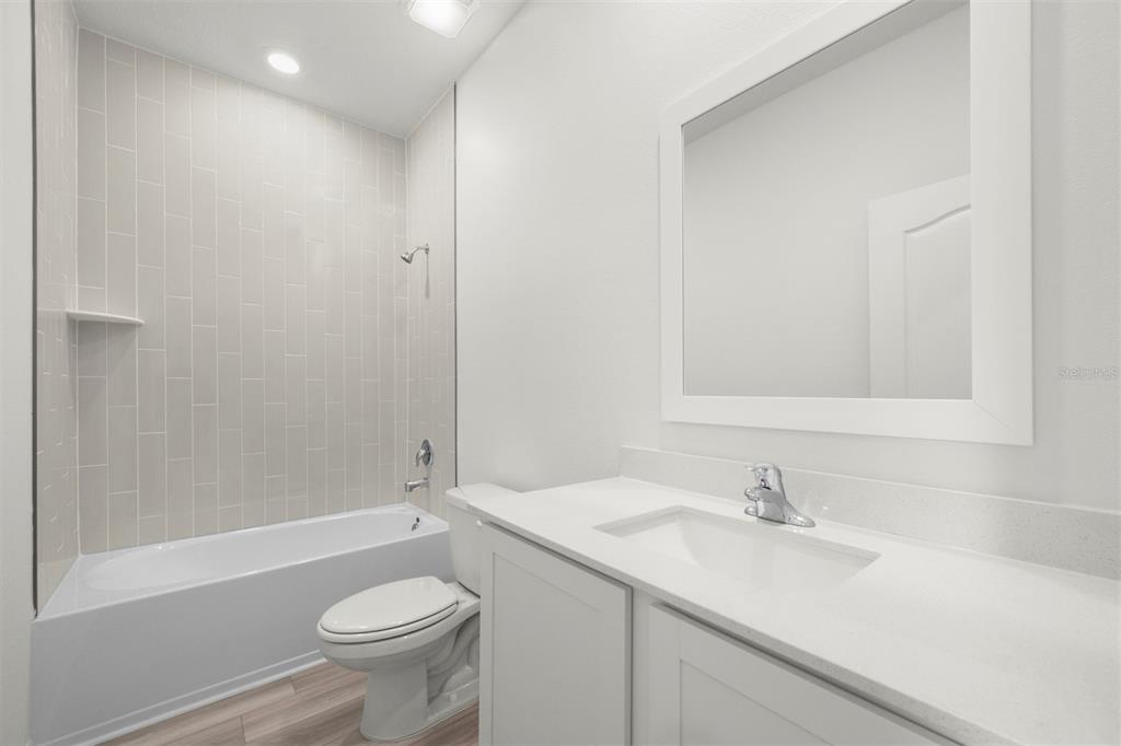 13300 Tula Loop Astatula, FL 34705 - Photo 16 of 18 a bathroom with a sink a toilet and shower