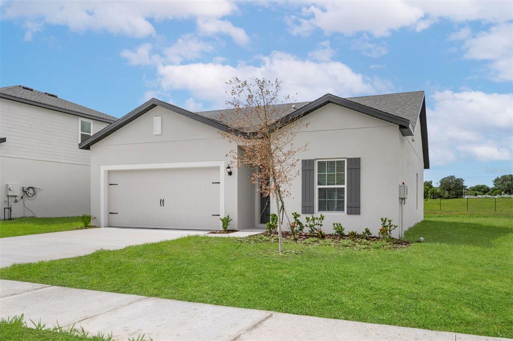 13300 Tula Loop Astatula, FL 34705 - Photo 2 of 18 a view of a house with a yard
