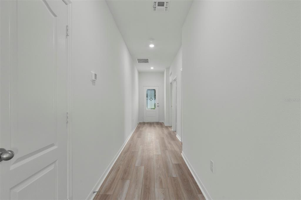 13300 Tula Loop Astatula, FL 34705 - Photo 8 of 18 a view of a hallway with wooden floor