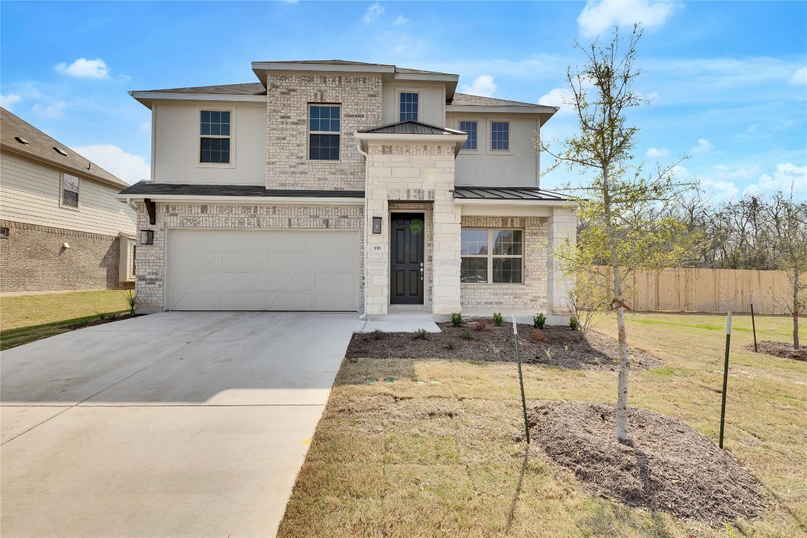 a view of a white house with large windows next to a yard