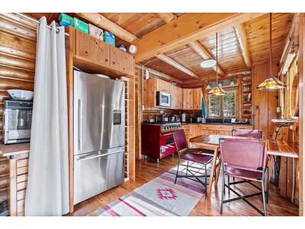 a open kitchen with stainless steel appliances granite countertop a refrigerator and microwave