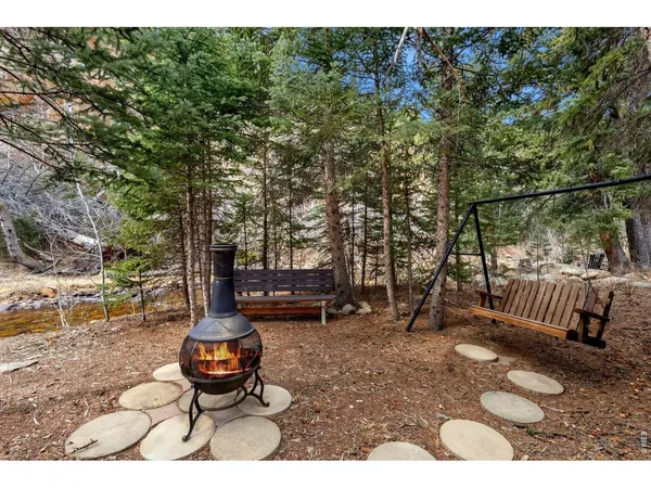 a backyard of a house with barbeque oven table and chairs