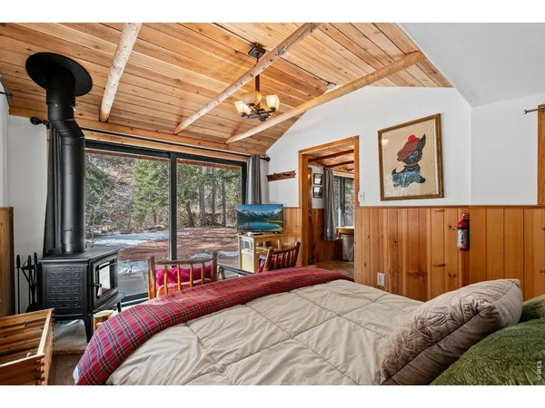 a bedroom with a bed next to a window with the outer view