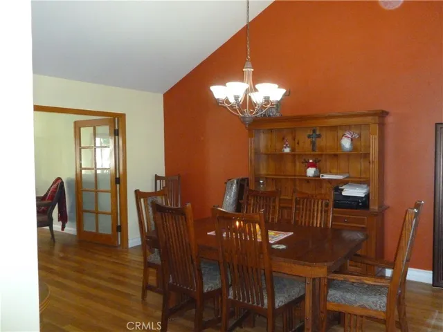 a view of a dining room with furniture and chandelier