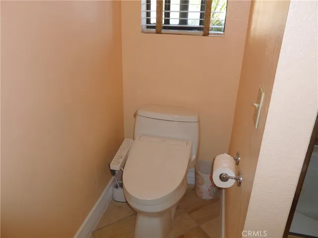 a toilet sitting in a bathroom next to a sink
