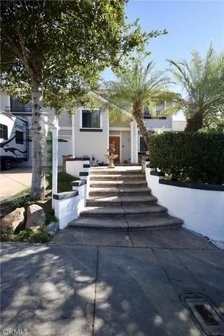 a view of a patio with table and chairs and potted plants