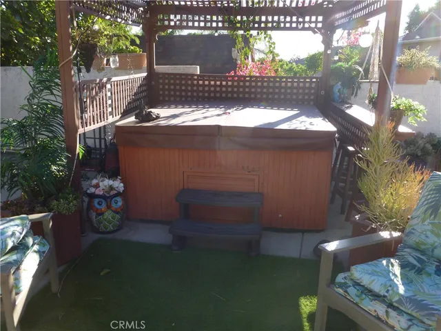 a view of a swimming pool with a lawn chairs and palm tree