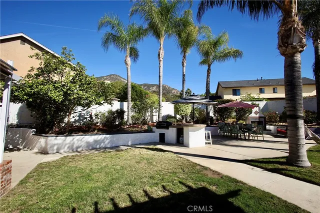 a swimming pool with outdoor seating and yard