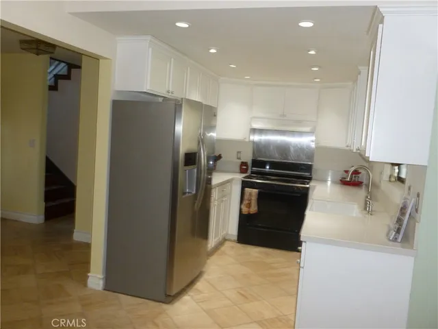a kitchen with a refrigerator and a sink