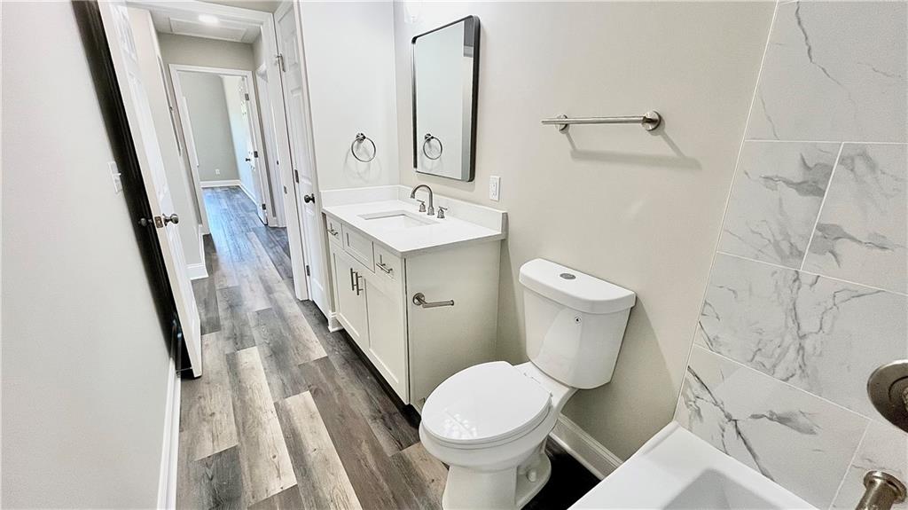 5 Green Road Griffin, GA 30224 - Photo 29 of 34 a bathroom with a sink a toilet a mirror and shower