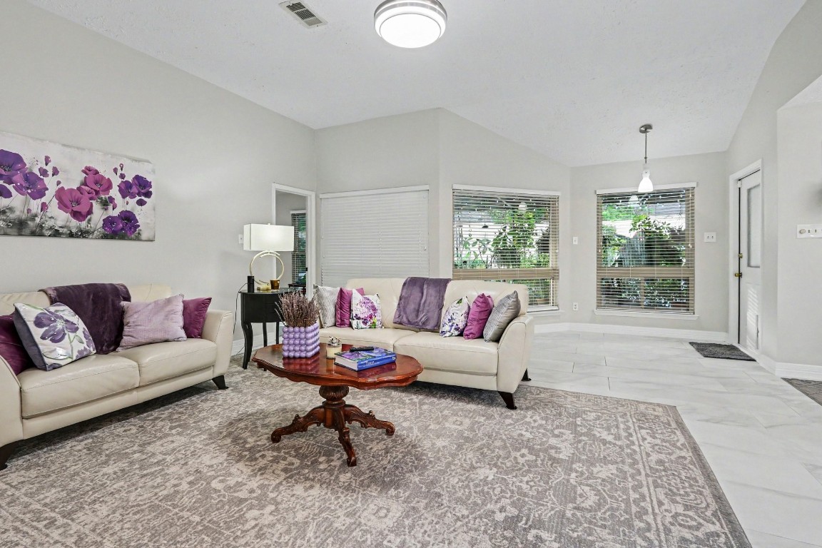 8327 Spring Wind Drive Houston, TX 77040 - Photo 6 of 30 Plenty of large windows bring in the natural light and give great views to the lush landscaping