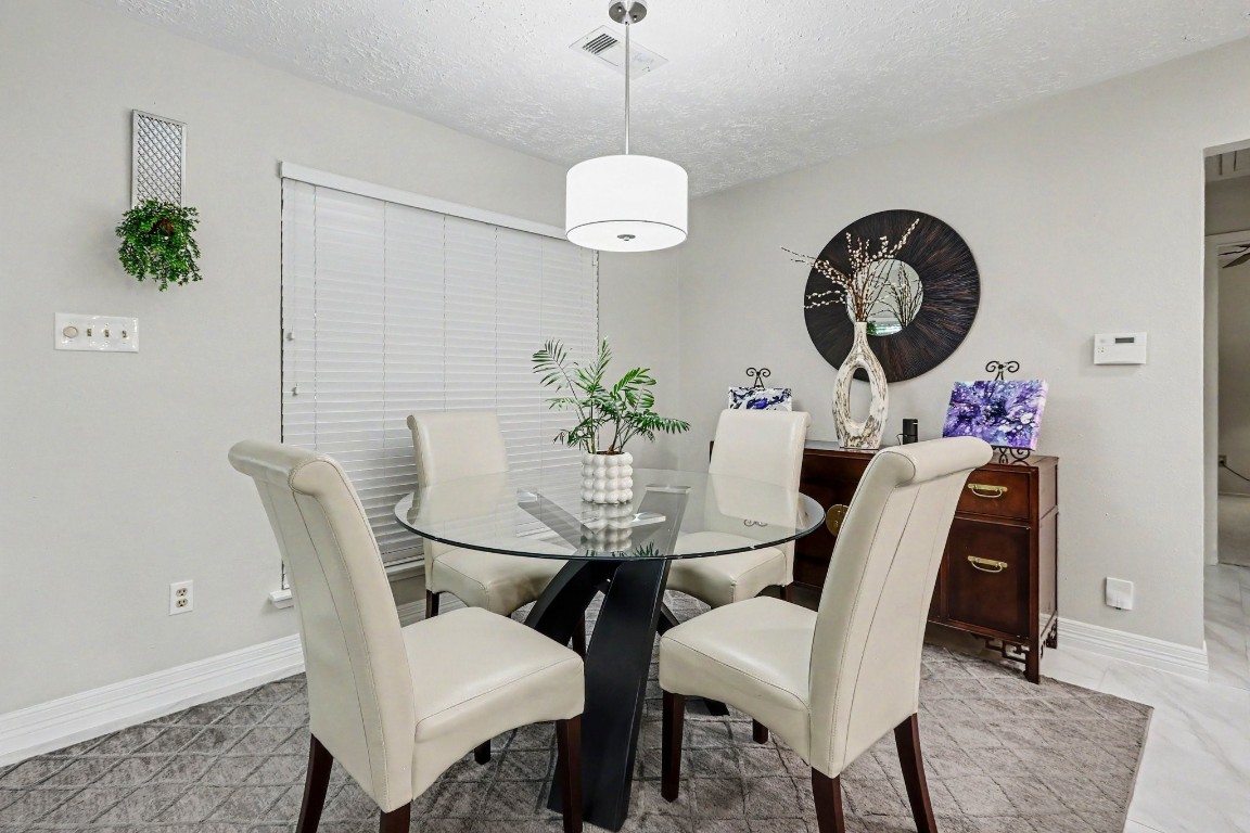 8327 Spring Wind Drive Houston, TX 77040 - Photo 8 of 30 With the dining area open to the kitchen, entertaining is effortless and guests can mingle with ease