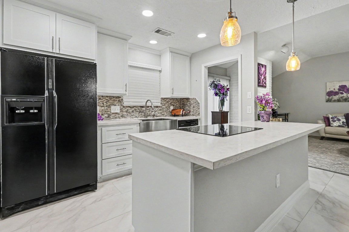 8327 Spring Wind Drive Houston, TX 77040 - Photo 10 of 30 Beautifully updated kitchen with shaker style cabinets and quartz countertops