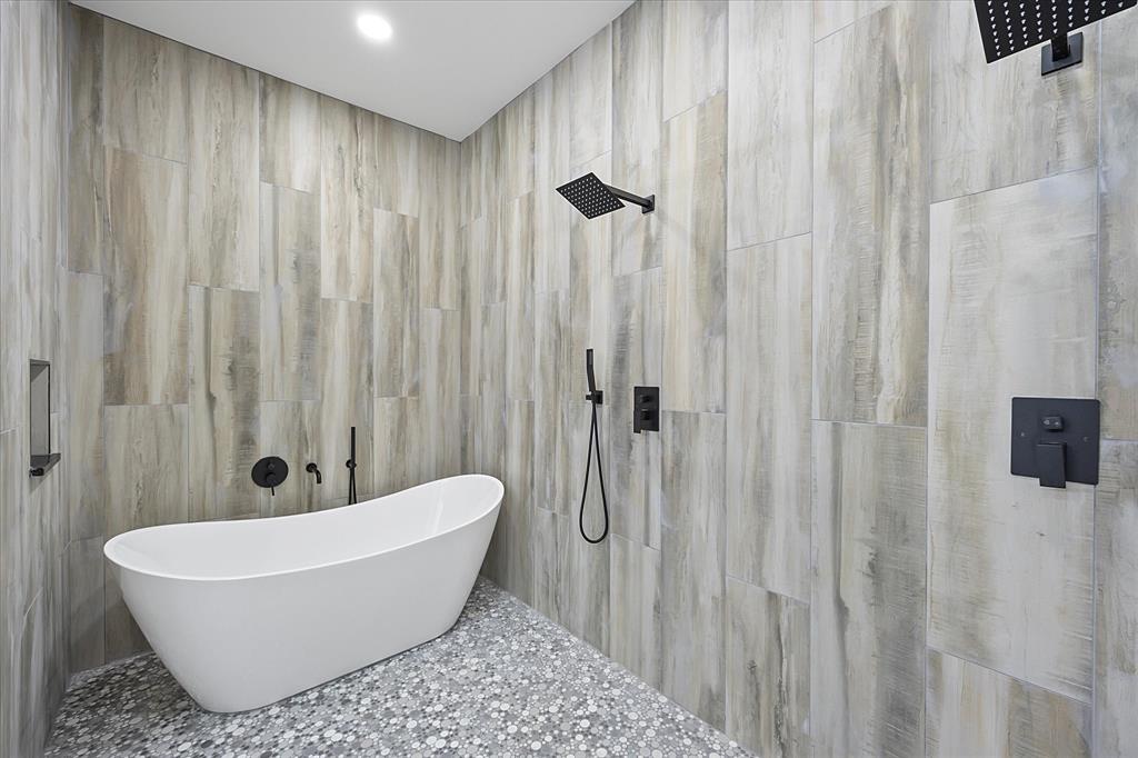 2811 Rodeo Drive Quinlan, TX 75474 - Photo 11 of 35 Full bathroom featuring tiled shower, tile walls, and a freestanding tub