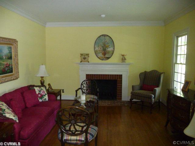 12013 Reeds Bluff Lane Midlothian, VA 23113 - Photo 5 of 12 a living room with furniture a mirror and a fireplace