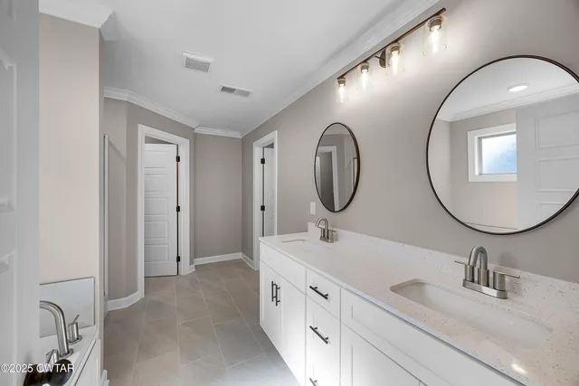 a bathroom with a double vanity sink double and mirror