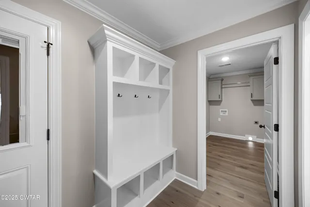 a view of a hallway with closet and wooden floor
