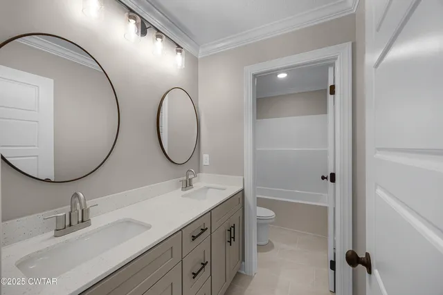 a bathroom with a double vanity sink and a mirror