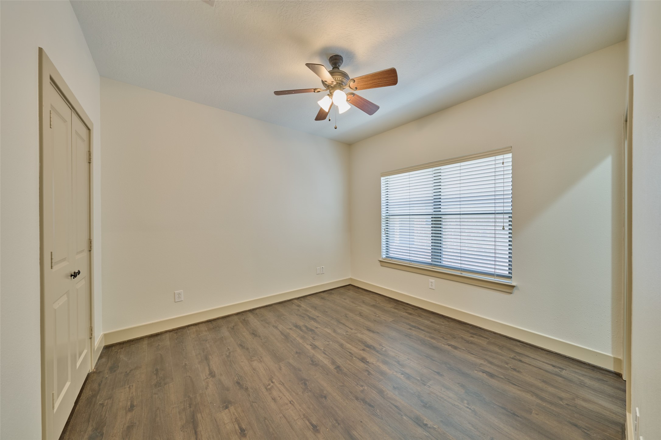 2422 Navigation Boulevard, Unit E Houston, TX 77003 - Photo 26 of 29 a view of an empty room with wooden floor and a window
