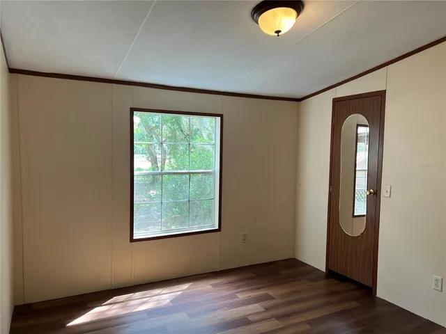 a view of a livingroom with wooden floor and window
