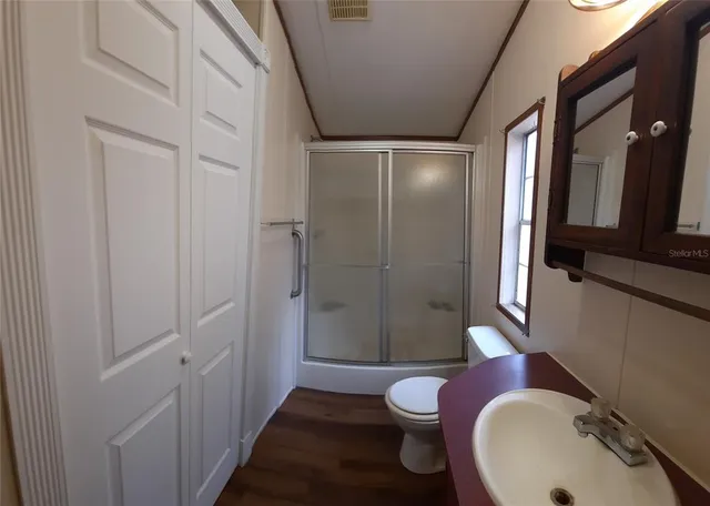 a bathroom with a sink toilet and shower