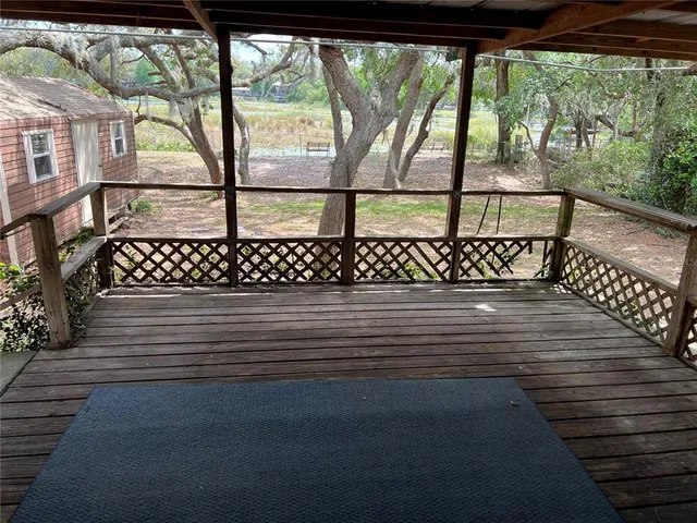 a view of a wooden deck with a yard