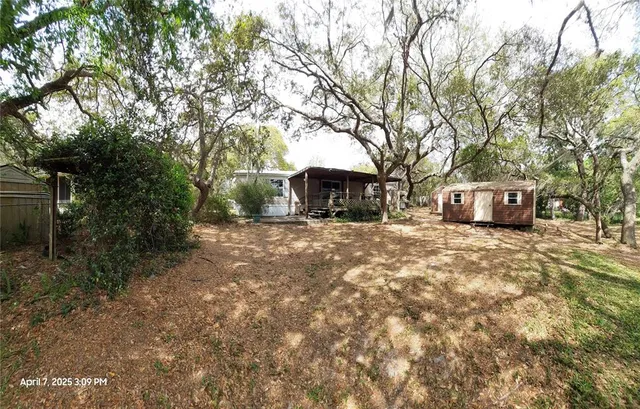 a view of a house with a yard covered in snow