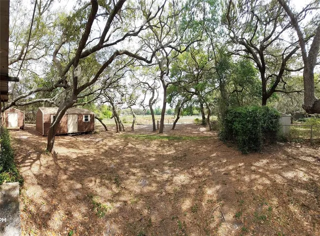 a view of outdoor space with deck and trees