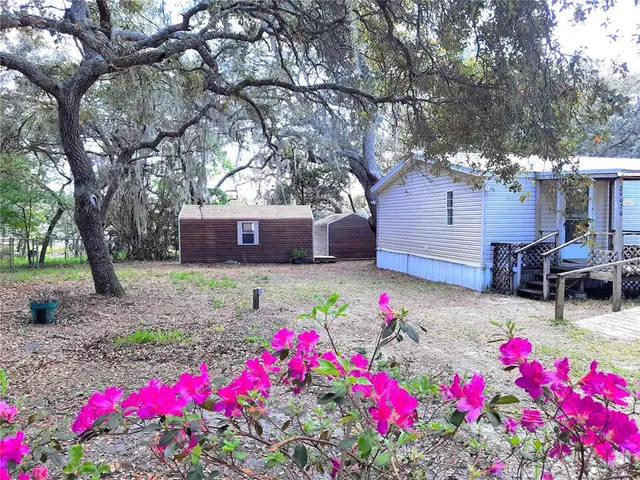 a house view with a sitting space and garden