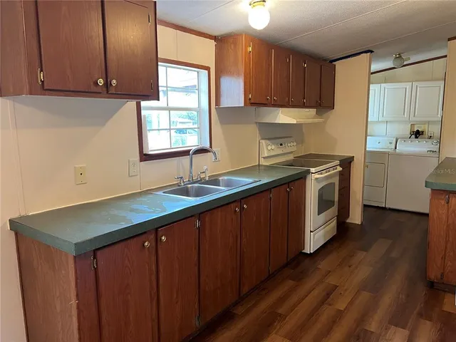 a kitchen with a sink window and cabinets