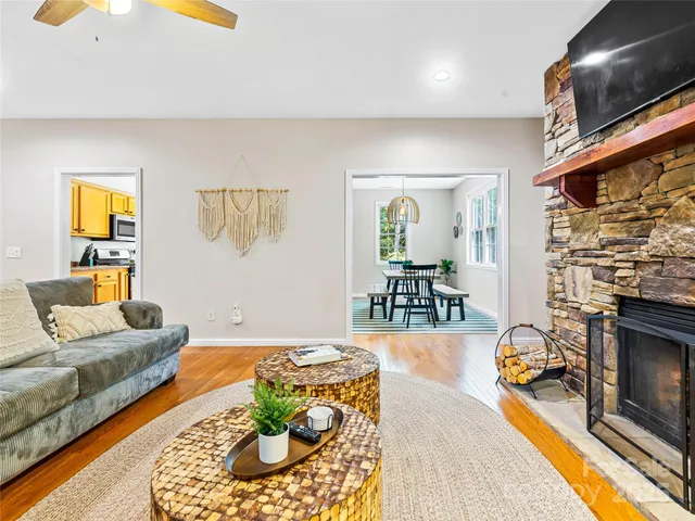 a kitchen with stainless steel appliances granite countertop a refrigerator a stove and a wooden floor