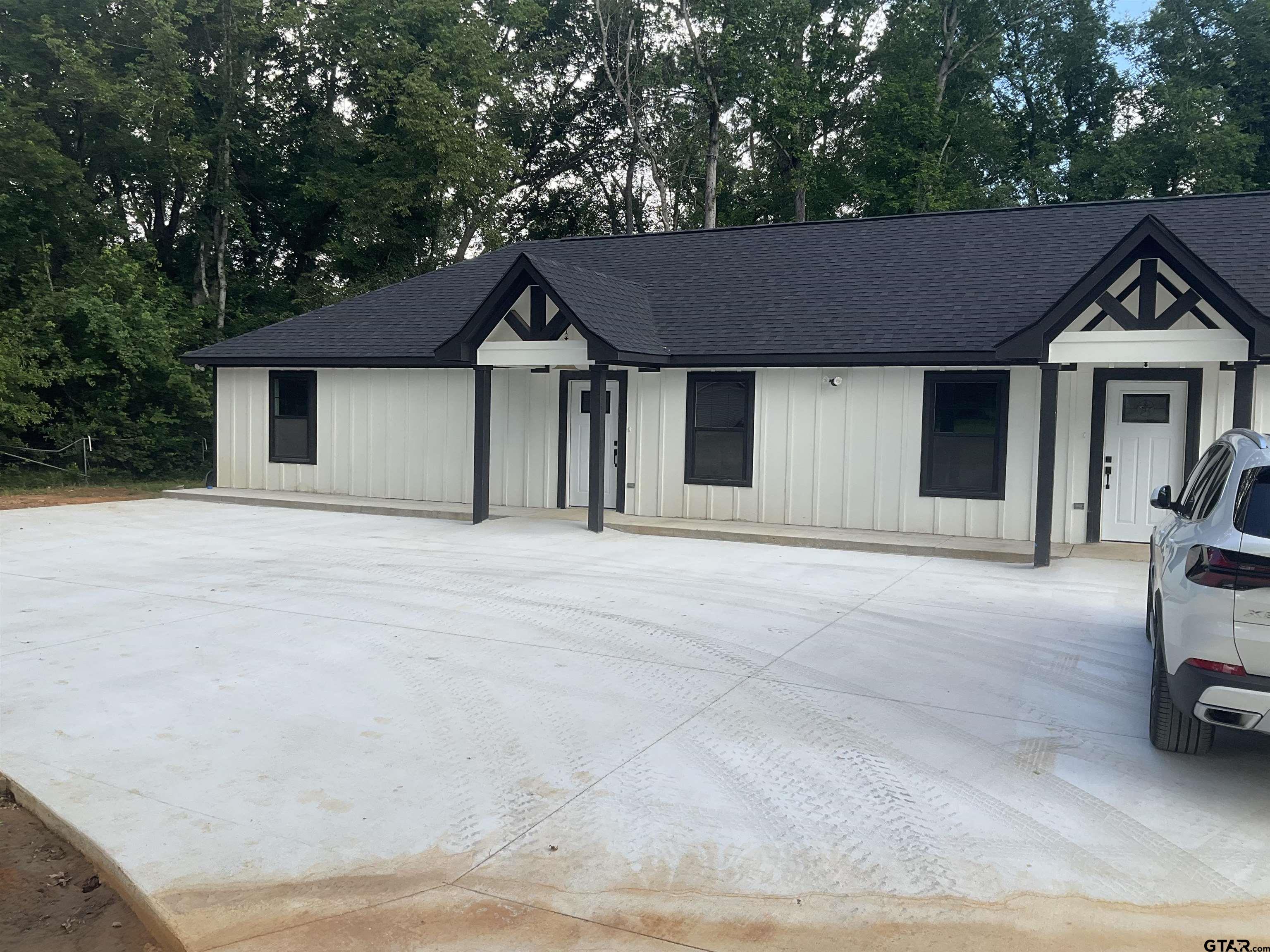 13220 Teton Road Tyler, TX 75709 - Photo 16 of 35 a front view of a house with a yard and garage