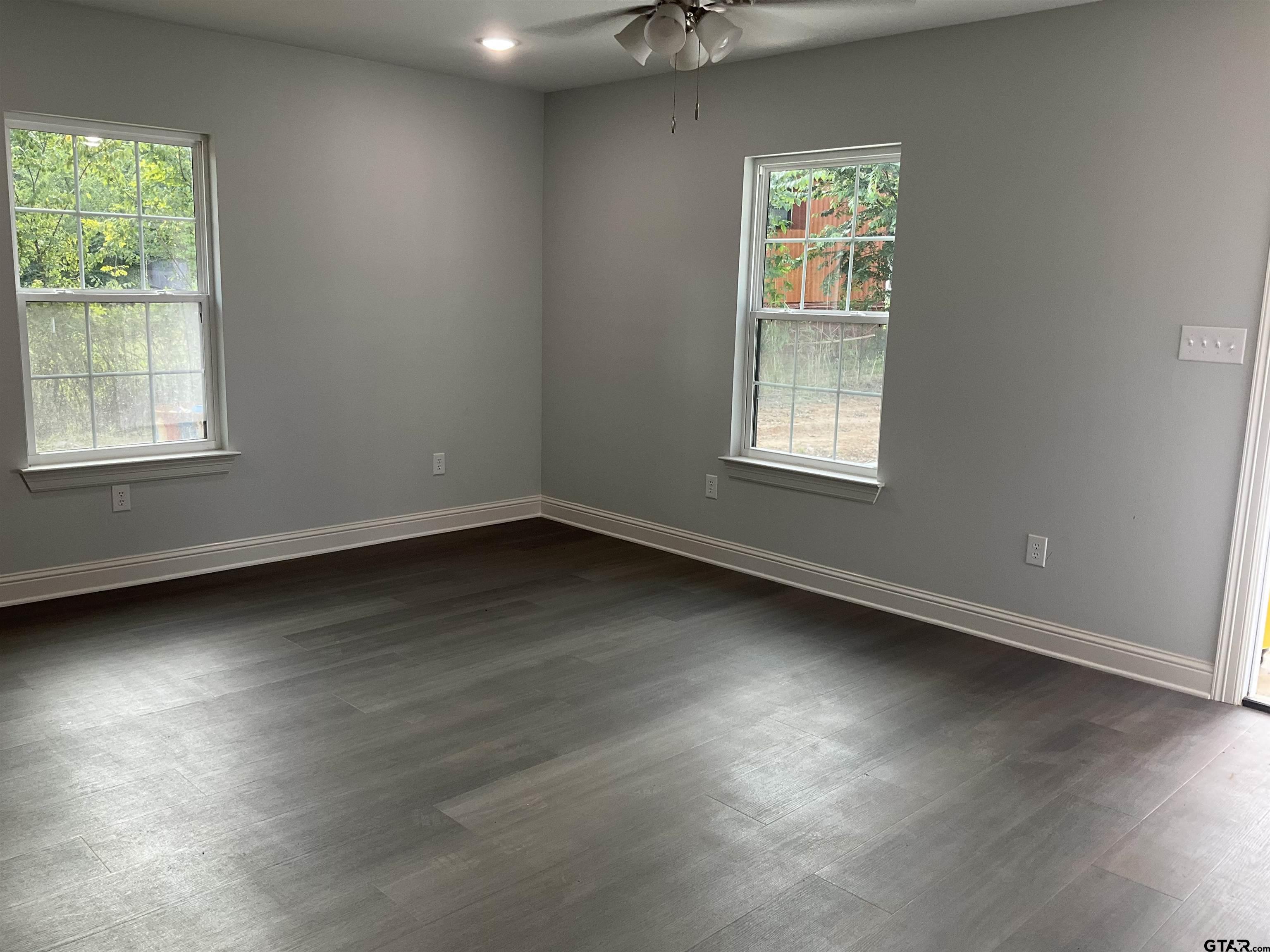 13220 Teton Road Tyler, TX 75709 - Photo 19 of 35 an empty room with wooden floor and windows