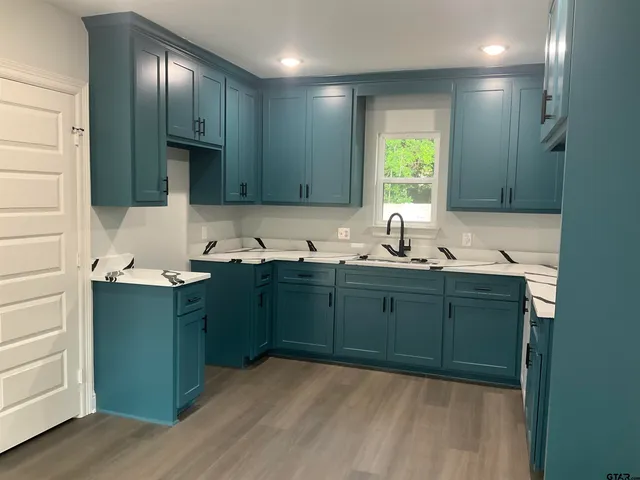 a kitchen with sink and cabinets