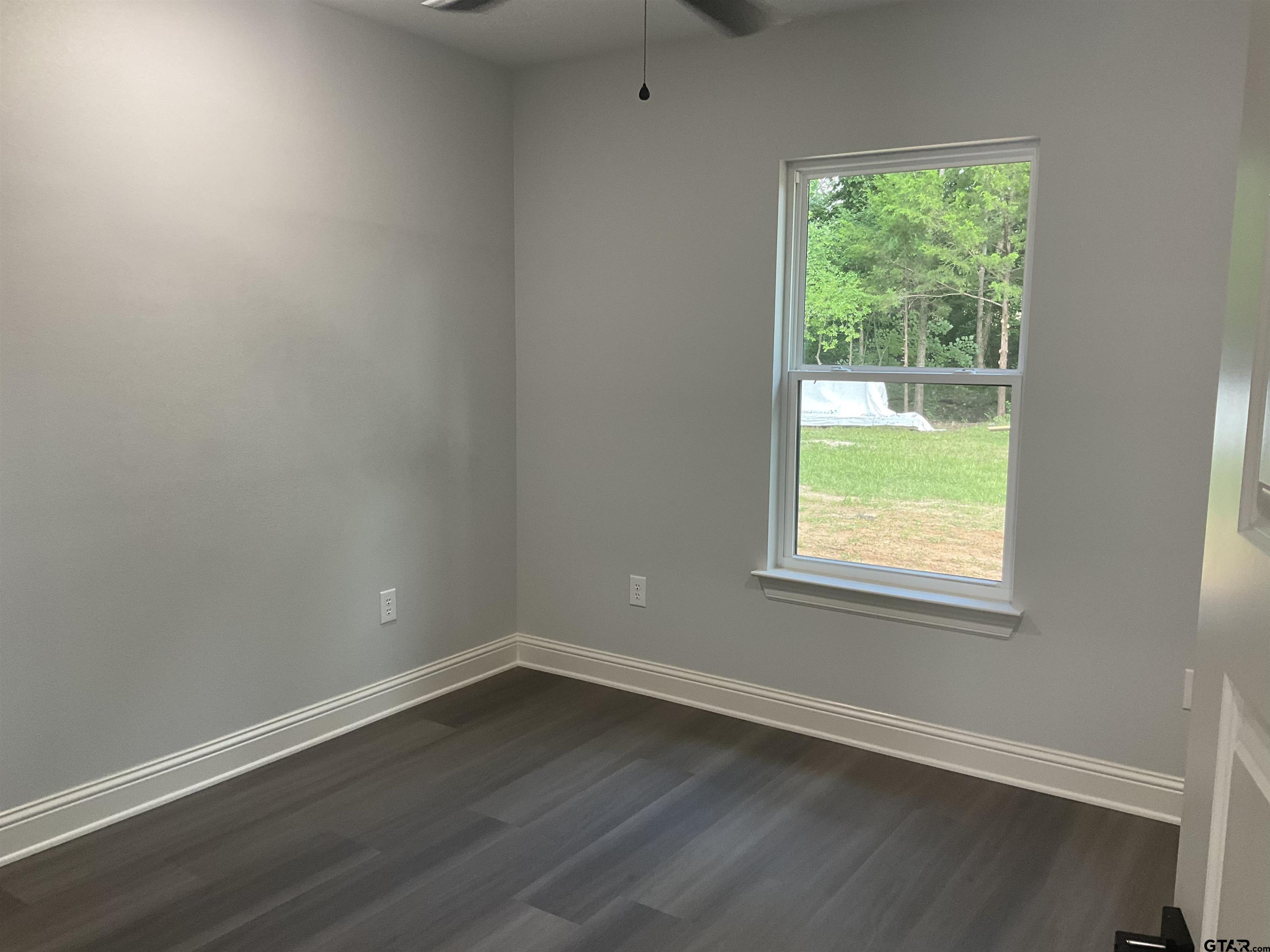 13220 Teton Road Tyler, TX 75709 - Photo 22 of 35 an empty room with wooden floor and windows