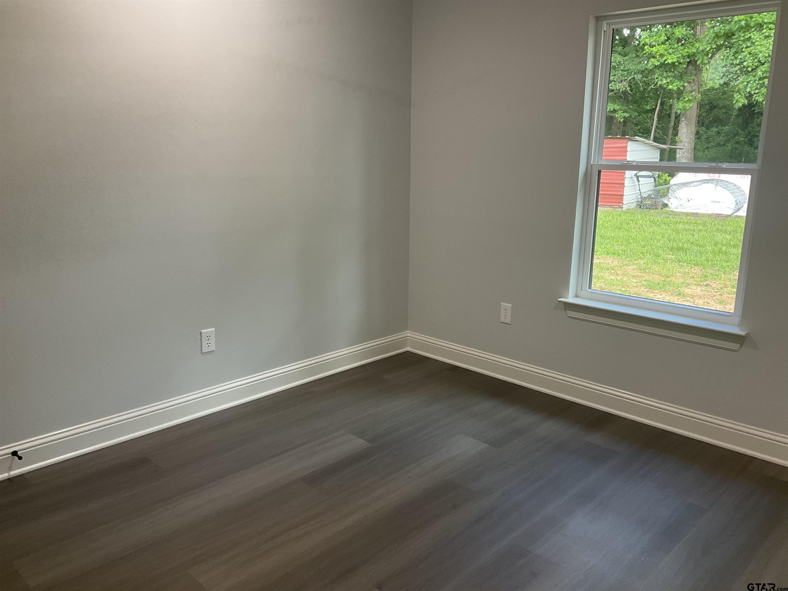 13220 Teton Road Tyler, TX 75709 - Photo 27 of 35 an empty room with wooden floor and windows