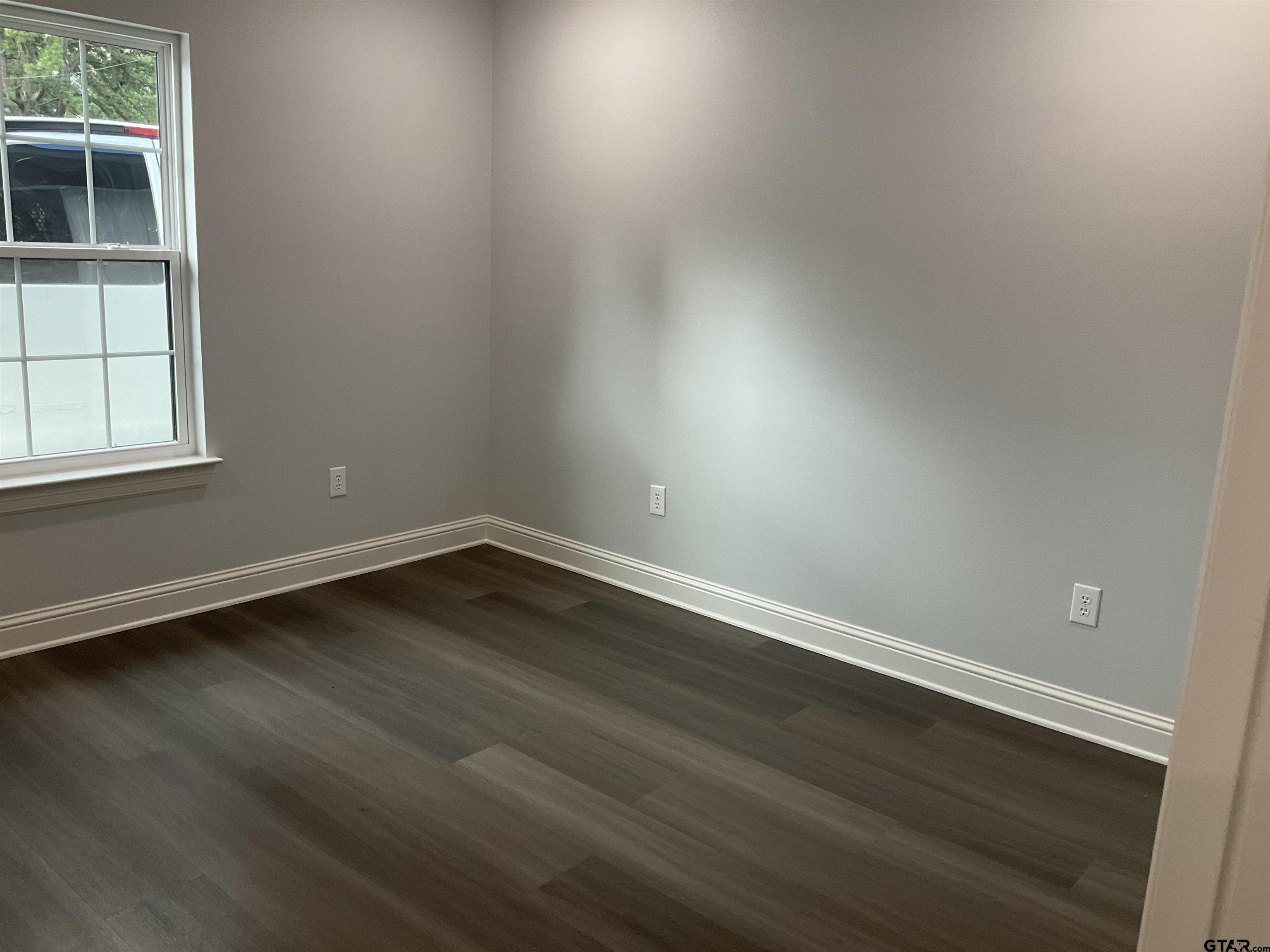 13220 Teton Road Tyler, TX 75709 - Photo 29 of 35 an empty room with wooden floor and windows