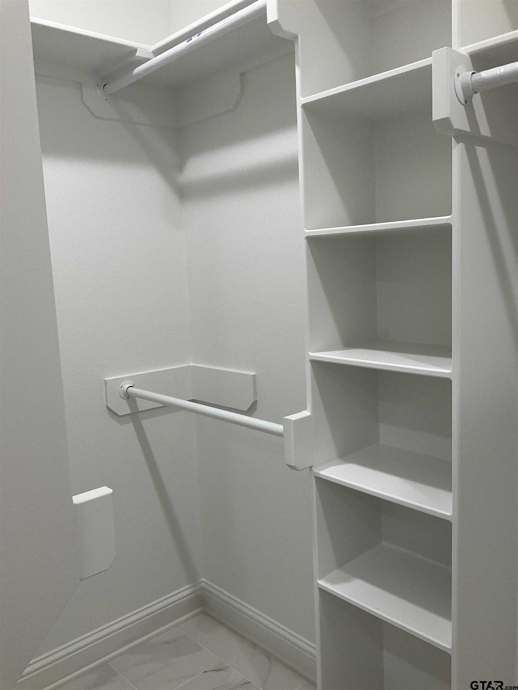 13220 Teton Road Tyler, TX 75709 - Photo 34 of 35 a view of walk in closet with empty racks