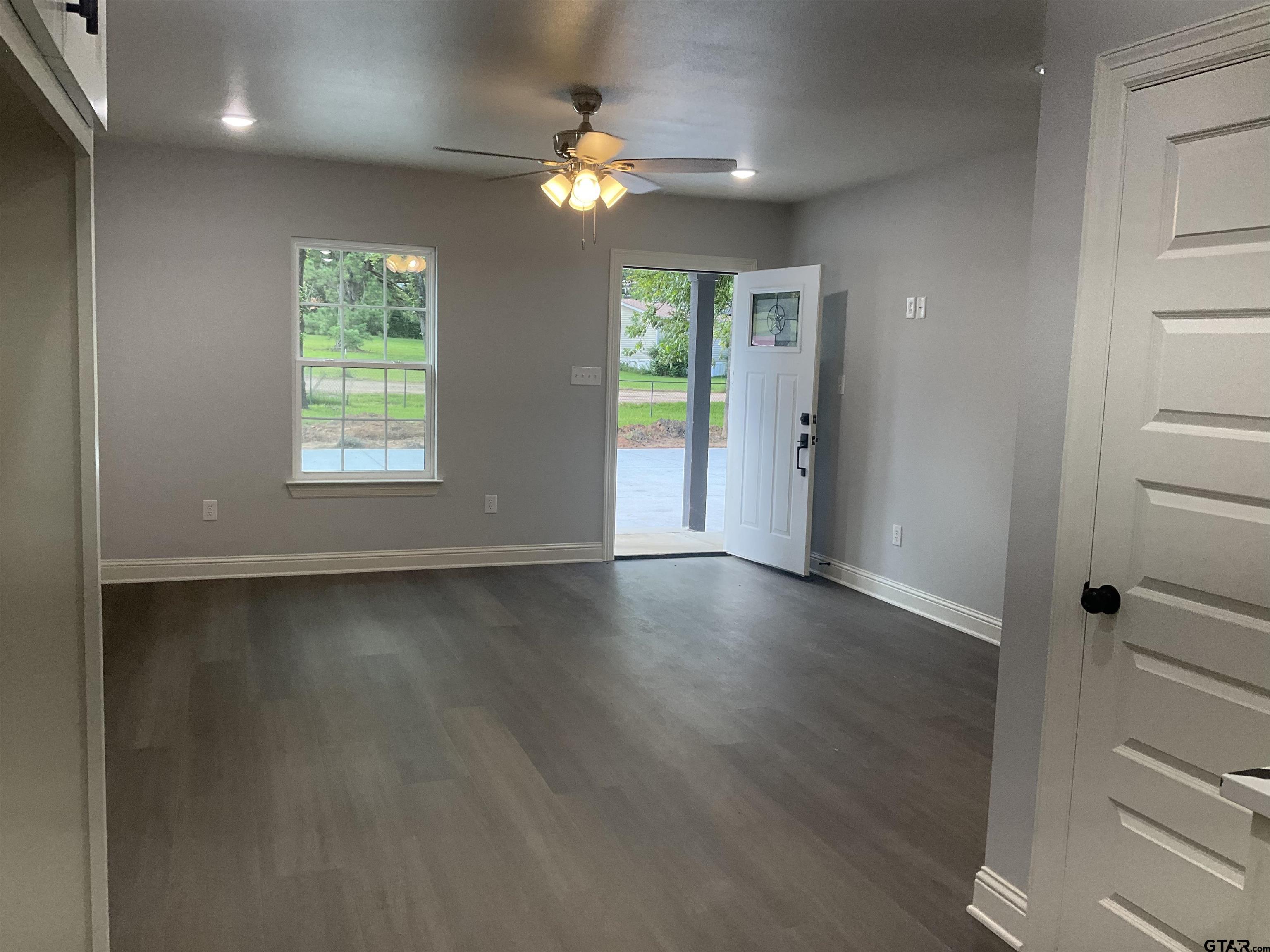 13220 Teton Road Tyler, TX 75709 - Photo 5 of 35 an empty room with wooden floor and windows