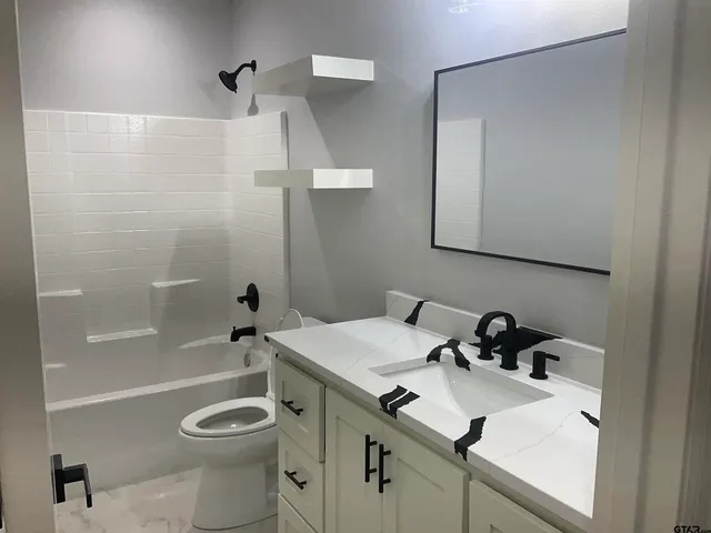 a bathroom with a sink a toilet and a bathtub