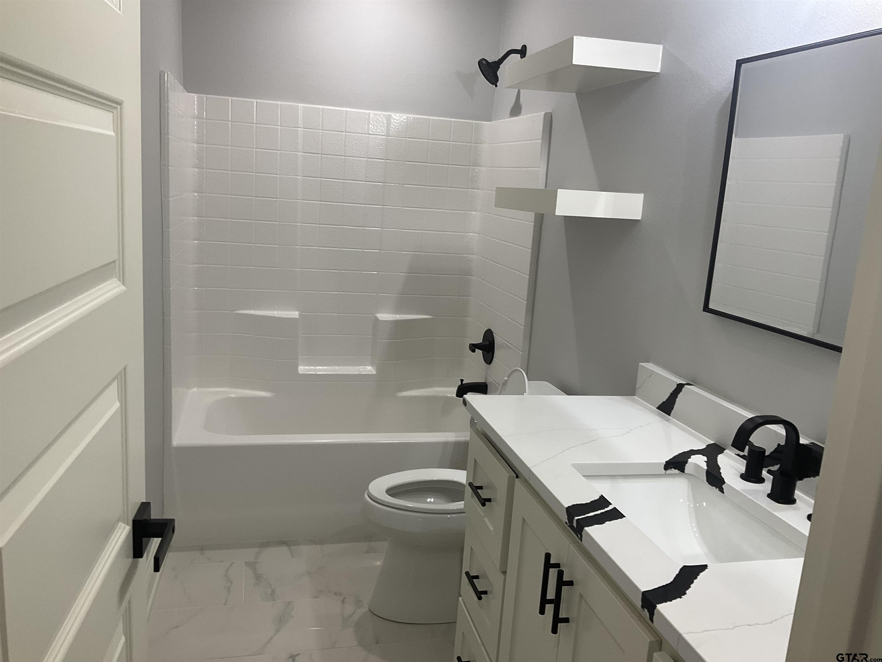 13220 Teton Road Tyler, TX 75709 - Photo 10 of 35 a bathroom with a sink toilet and shower