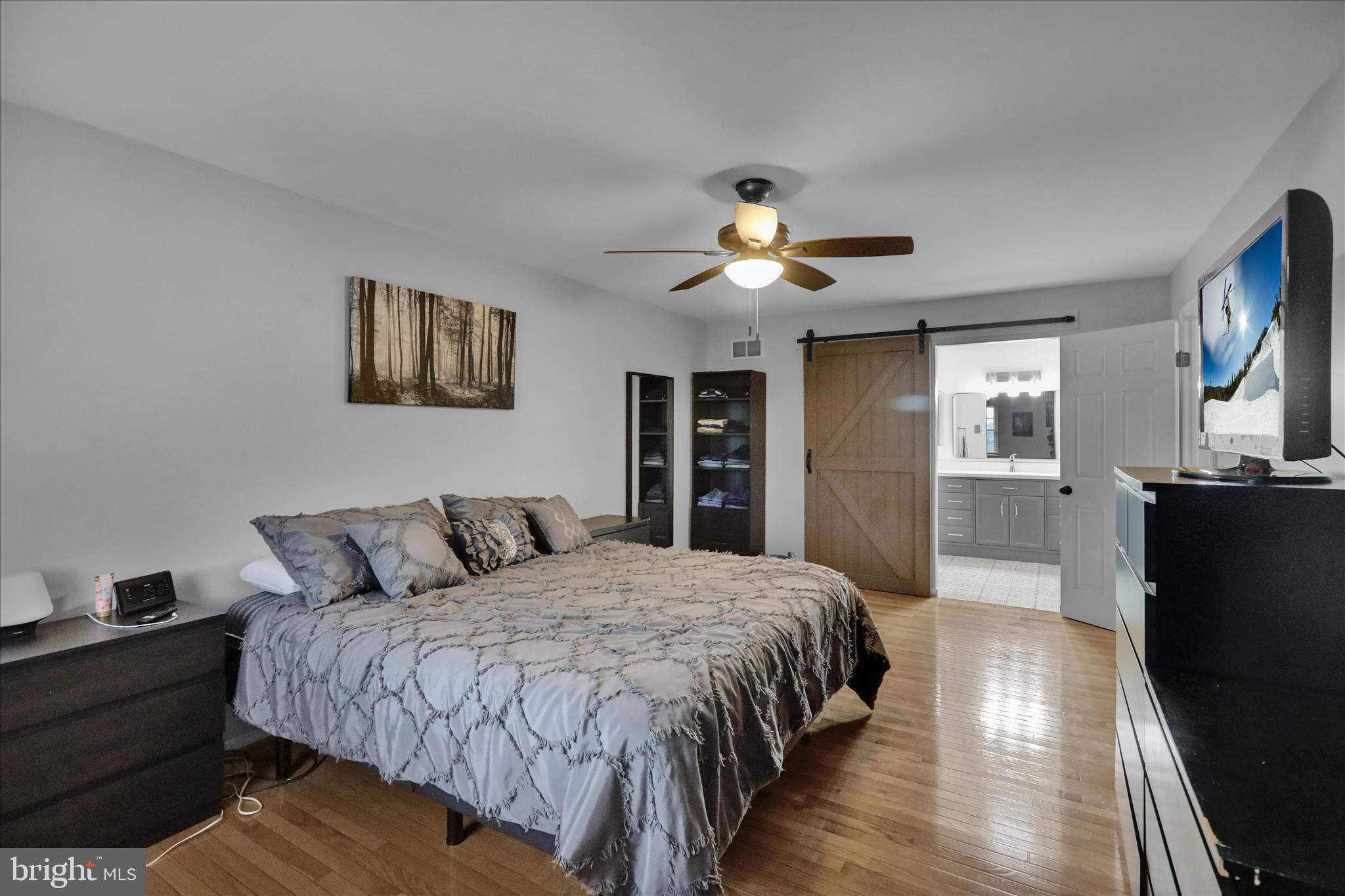 2930 Reedy Road Sinking Spring, PA 19608 - Photo 19 of 45 a spacious bedroom with a bed and a chandelier