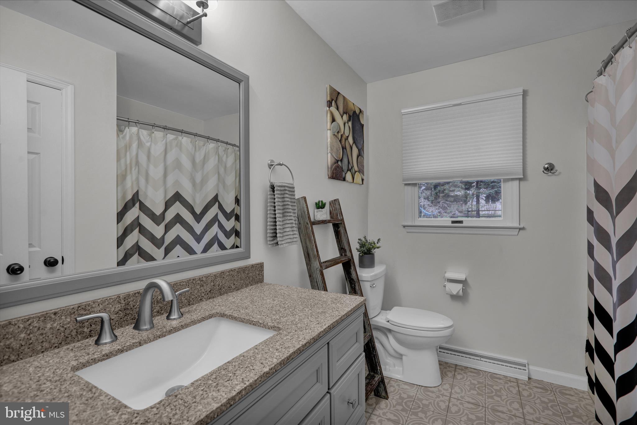 2930 Reedy Road Sinking Spring, PA 19608 - Photo 25 of 45 a bathroom with a granite countertop sink toilet and a mirror