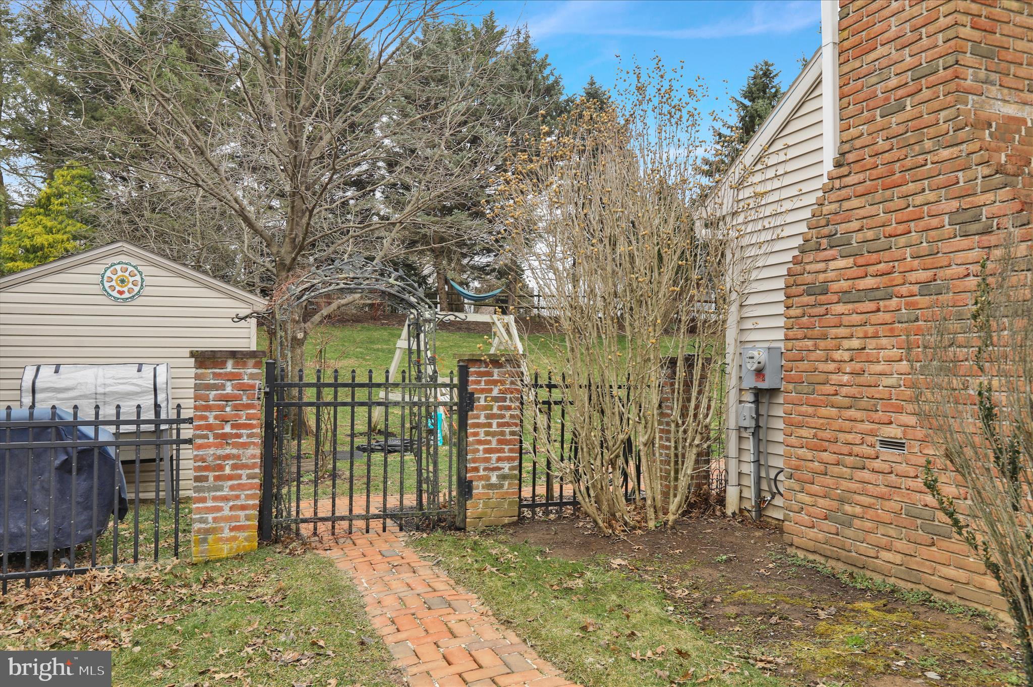 2930 Reedy Road Sinking Spring, PA 19608 - Photo 35 of 45 a view of a brick house with large windows and a yard